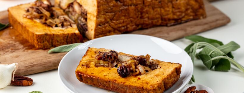 slice of tofurky with apricot stuffing on a white plate